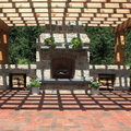 cool-white-stoned-outdoor-fireplace-with-decorative-plants-also-wooden-pergola-canopy-design.jpg