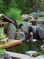 landscape-design-ideas-natural-stones-waterfall-wooden-deck-outdoor-furniture